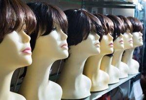 Mannequins With Brown Haired And Brunet Style Wigs On Shelves Of Hair Salon